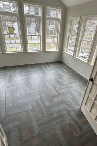 wood look tile floor installation in a Dedham sun room